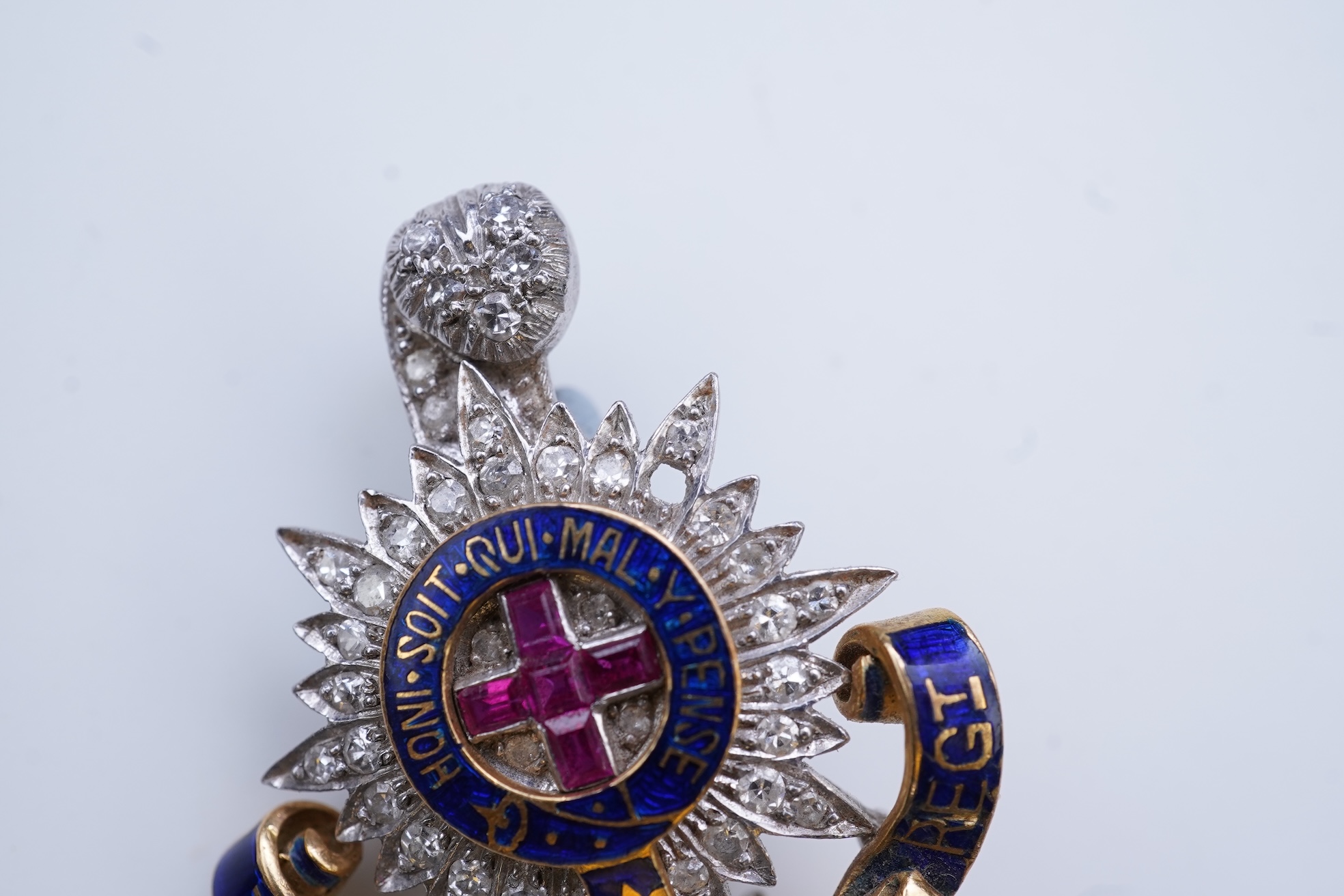 A ruby, enamel and diamond Royal Sussex Regiment badge, mid 20th century